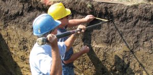 Scientists excavating site.